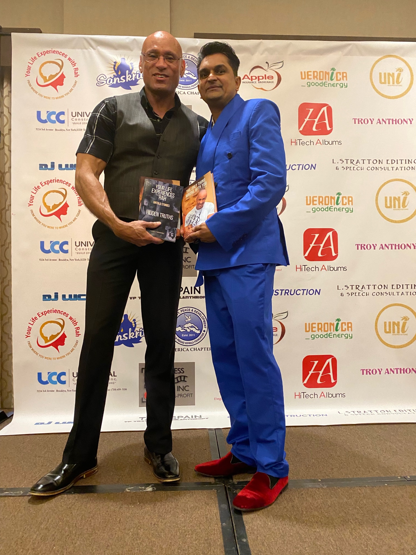 Bernard Owens exchanging books with a fellow author at a conference