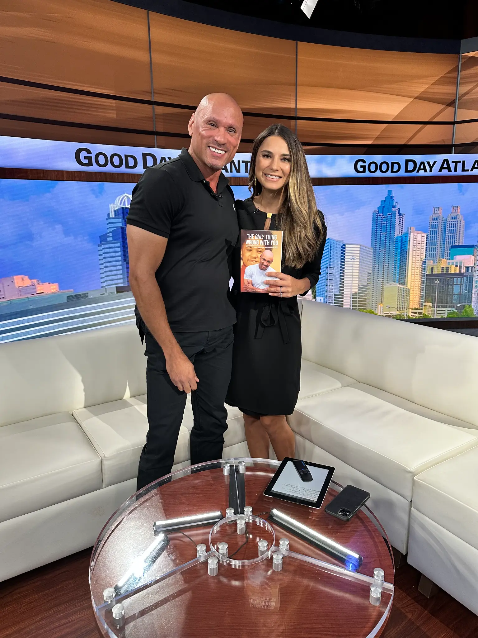 Bernard Owens and host holding book on Good Day Atlanta