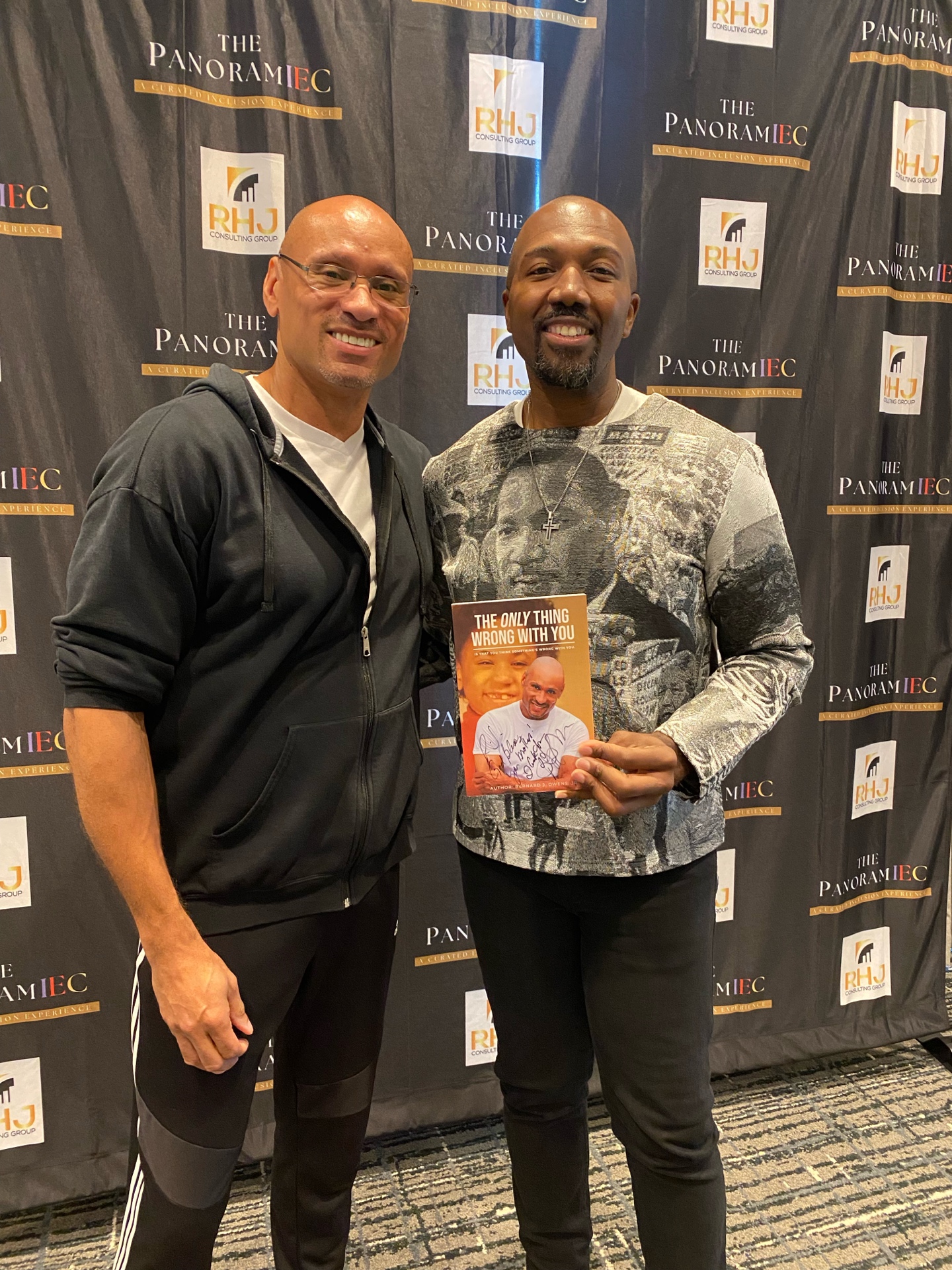 Bernard Owens signing a book for an attendee at the Panoramic Experience (RHJ Consulting Group)